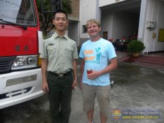 Visit fireman - Brent is taking a picture with a fireman.